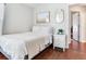 Bright bedroom featuring wood floors, a comfortable bed, and tasteful decor at 24811 Gun Smoke Dr, Land O Lakes, FL 34639