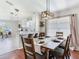 Open concept dining room features hardwood floors and modern lighting fixtures above the table at 24811 Gun Smoke Dr, Land O Lakes, FL 34639