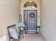 Inviting entryway with decorative wreath, arched window, and welcome sign at 24811 Gun Smoke Dr, Land O Lakes, FL 34639