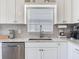 Close up of kitchen showing updated granite countertops and stainless steel dishwasher and sink at 24811 Gun Smoke Dr, Land O Lakes, FL 34639