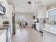 Kitchen with modern lighting fixtures, stainless steel appliances, and white cabinetry at 24811 Gun Smoke Dr, Land O Lakes, FL 34639