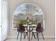 Kitchen eating area featuring a rounded window overlooking a landscaped yard and small table set for two at 24811 Gun Smoke Dr, Land O Lakes, FL 34639
