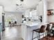 Bright kitchen with white cabinetry, a breakfast bar, and modern pendant lighting at 24811 Gun Smoke Dr, Land O Lakes, FL 34639