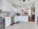 Bright kitchen features white cabinets, stainless steel appliances, and a modern lighting fixture at 24811 Gun Smoke Dr, Land O Lakes, FL 34639