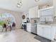 Kitchen with modern lighting fixtures, stainless steel appliances, and white cabinetry at 24811 Gun Smoke Dr, Land O Lakes, FL 34639