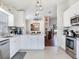 Bright kitchen with stainless steel appliances and open concept dining and living space at 24811 Gun Smoke Dr, Land O Lakes, FL 34639