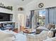 Bright living room featuring hardwood floors with a sliding glass door to the patio at 24811 Gun Smoke Dr, Land O Lakes, FL 34639