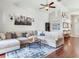 Spacious living room with a large sectional sofa, decorative rug, and a modern ceiling fan at 24811 Gun Smoke Dr, Land O Lakes, FL 34639