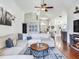 Bright living room showcasing a sectional sofa, hardwood floors, and an open floor plan at 24811 Gun Smoke Dr, Land O Lakes, FL 34639