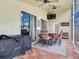 Screened patio with grill and outdoor seating with backyard view at 24811 Gun Smoke Dr, Land O Lakes, FL 34639