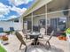Inviting screened-in patio with comfortable seating and a fire pit, ideal for outdoor entertaining at 24811 Gun Smoke Dr, Land O Lakes, FL 34639