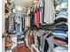 Walk-in closet offers ample storage space with shelving and hanging racks for organization at 24811 Gun Smoke Dr, Land O Lakes, FL 34639