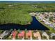 Beautiful community aerial view, with homes bordering a dark waterway and lush forest at 2691 Saddlewood Ln, Palm Harbor, FL 34685