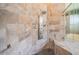 Shower features decorative stone and custom hardware at 2691 Saddlewood Ln, Palm Harbor, FL 34685