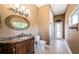 Bathroom featuring a vanity, decorative mirror, and tiled flooring at 2691 Saddlewood Ln, Palm Harbor, FL 34685