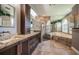 Luxurious bathroom features double sinks, granite countertops, glass shower, and large soaking tub at 2691 Saddlewood Ln, Palm Harbor, FL 34685