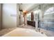 Elegant primary bathroom featuring dual vanities, soaking tub, and tiled shower with glass door at 2691 Saddlewood Ln, Palm Harbor, FL 34685