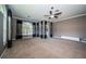 Comfortable bedroom featuring carpet, custom curtains, ceiling fan, and access to outdoor living at 2691 Saddlewood Ln, Palm Harbor, FL 34685