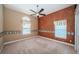 Bedroom featuring a ceiling fan and decorative accent wall with two windows at 2691 Saddlewood Ln, Palm Harbor, FL 34685
