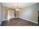 Formal dining room featuring dark wood floors and decorative chandelier at 2691 Saddlewood Ln, Palm Harbor, FL 34685