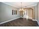 An empty formal dining room featuring hard wood floors and an archway to the left at 2691 Saddlewood Ln, Palm Harbor, FL 34685