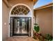 Close up of the front door with decorative glass and transom window at 2691 Saddlewood Ln, Palm Harbor, FL 34685