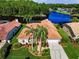 Aerial view of a beautiful house showcasing a tile roof, well-manicured landscaping and large trees at 2691 Saddlewood Ln, Palm Harbor, FL 34685