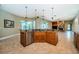 Kitchen with granite countertops and stainless appliances opens to living area with fireplace at 2691 Saddlewood Ln, Palm Harbor, FL 34685