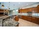 Elegant kitchen featuring granite counters, stone backsplash, breakfast bar and ample cabinet space at 2691 Saddlewood Ln, Palm Harbor, FL 34685