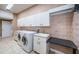 Well-appointed laundry room with machines and lots of storage at 2691 Saddlewood Ln, Palm Harbor, FL 34685