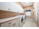 Functional laundry room with counter space, storage and appliances at 2691 Saddlewood Ln, Palm Harbor, FL 34685