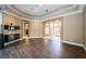 Spacious living room featuring wood floors, decorative lighting, and an archway at 2691 Saddlewood Ln, Palm Harbor, FL 34685