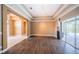 Open living space with hardwood floors and sliding doors leading to the pool area at 2691 Saddlewood Ln, Palm Harbor, FL 34685