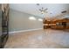 Spacious living area features tile flooring, a ceiling fan, and an open layout to the kitchen at 2691 Saddlewood Ln, Palm Harbor, FL 34685