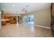 Bright open floor plan features tile floors, a ceiling fan, and access to the outdoor living space at 2691 Saddlewood Ln, Palm Harbor, FL 34685