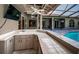 A covered bar near the pool and the backyard, with ample counter space at 2691 Saddlewood Ln, Palm Harbor, FL 34685