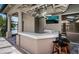 Covered outdoor bar with seating and a lake view for entertaining at 2691 Saddlewood Ln, Palm Harbor, FL 34685