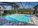 Beautiful in-ground pool and spa area with lovely stone tile at 2691 Saddlewood Ln, Palm Harbor, FL 34685