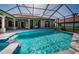 In-ground pool and hot tub with screened enclosure and beautiful lake view at 2691 Saddlewood Ln, Palm Harbor, FL 34685