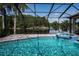 Sparkling in-ground pool and spa with lake view at 2691 Saddlewood Ln, Palm Harbor, FL 34685