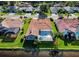 Beautiful rear view of home, highlighting a screened-in pool, spa, lush lawn, and waterfront access at 2691 Saddlewood Ln, Palm Harbor, FL 34685