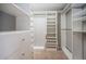 Spacious walk-in closet with custom shelving and drawers for all of your storage needs at 2691 Saddlewood Ln, Palm Harbor, FL 34685
