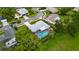 Aerial view of a home with a screened-in pool surrounded by lush greenery at 2914 Forest Cir, Seffner, FL 33584