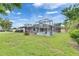 Spacious lawn featuring a screened pool enclosure and mature trees at 2914 Forest Cir, Seffner, FL 33584