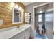 Bright bathroom featuring wood paneling, white vanity, and a shower at 2914 Forest Cir, Seffner, FL 33584