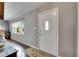 Entryway with a white door, gray walls, wood-look floor, and natural light at 2914 Forest Cir, Seffner, FL 33584