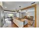 Bright open concept living area boasts wood beams, kitchen island and dining area at 2914 Forest Cir, Seffner, FL 33584