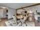 Open-concept living area with wood floors, a view of the kitchen, and neutral walls at 2914 Forest Cir, Seffner, FL 33584