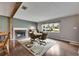 Cozy living room with a brick fireplace, area rug, and large window at 2914 Forest Cir, Seffner, FL 33584