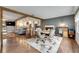 Open-concept living area with wood floors, a fireplace, and a view of the kitchen at 2914 Forest Cir, Seffner, FL 33584